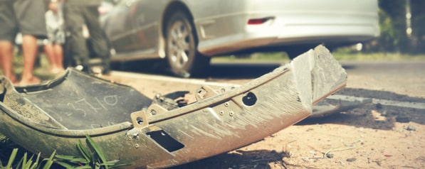 A detached car bumper on the road after a car accident in Pompano Beach