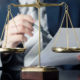 Lawyer doing paperwork in front of a US justice symbol