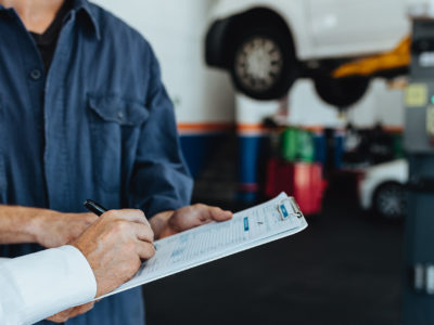 Signing paperwork at a mechanic - sue mechanic