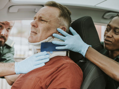 A man getting treated for his car injuries at the scene