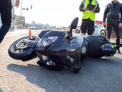 Black motorcycle on its side on the road after a motorcycle accident