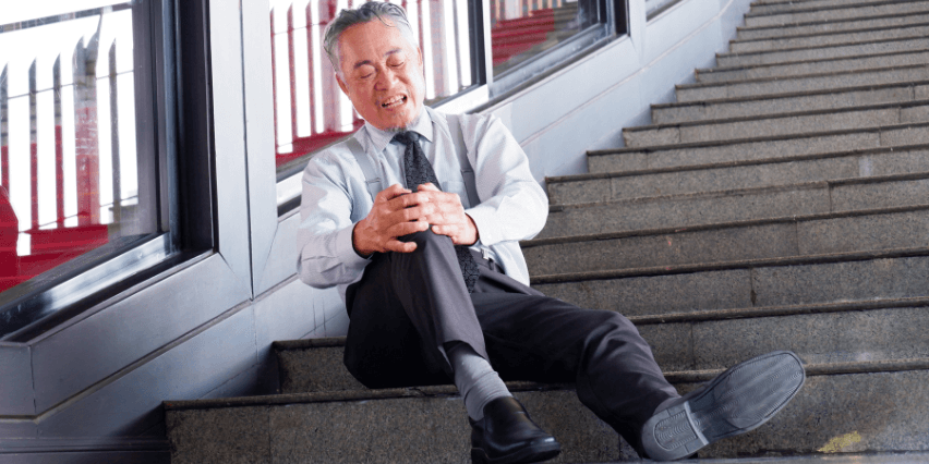 Man slipped and fell on stairs at office, no wet floor sign is seen.